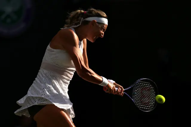 Victoria Azarenka hits a backhand shot