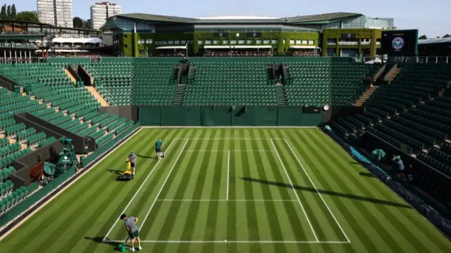 Ground staff prepare the courts