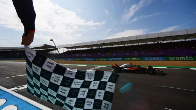 The chequered flag is waved for Lando Norris at the end of qualifying at Silverstone