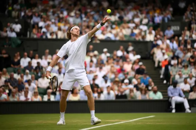 Andrey Rublev tosses the ball up to serve