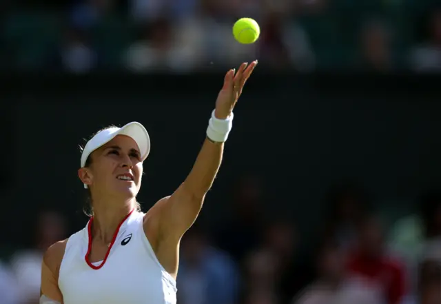 Belinda Bencic tosses the ball to serve