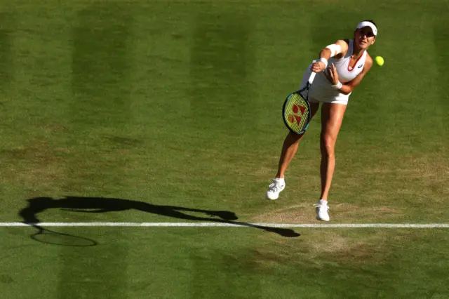 Belinda Bencic serves the ball on court