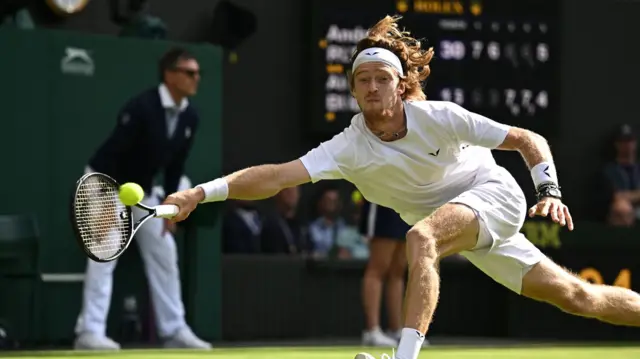 Andrey Rublev stretches for a ball