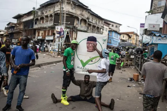 Supporters of the President of Sierra Leone and Leader of Sierra Leone People's party (SLPP), Julius Maada Bio, celebrate in the streets following his re-election in Freetown in June 27, 2023.