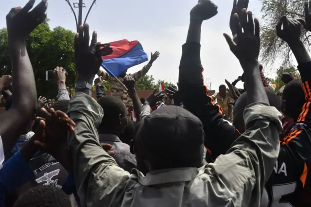 Protesters cheer Nigerien troops as they gather in front of the French Embassy in Niamey during a demonstration that followed a rally in support of Niger's junta in Niamey on July 30, 2023.