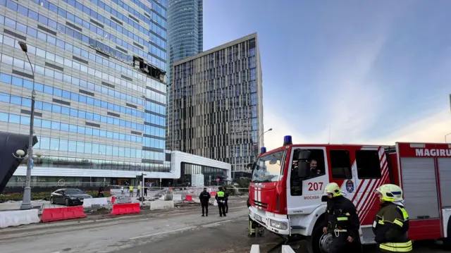 Security services in front of the damaged building