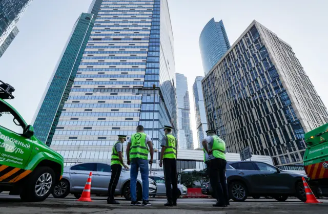 Police in front of the damaged building in Moscow's city centre