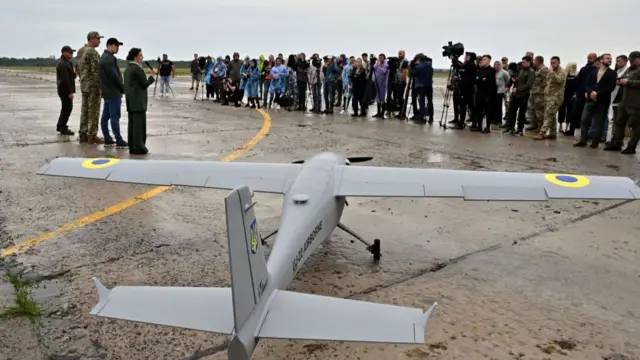 Journalists attend the presentation of a UJ-22 Airborne (UkrJet) reconnaissance drone