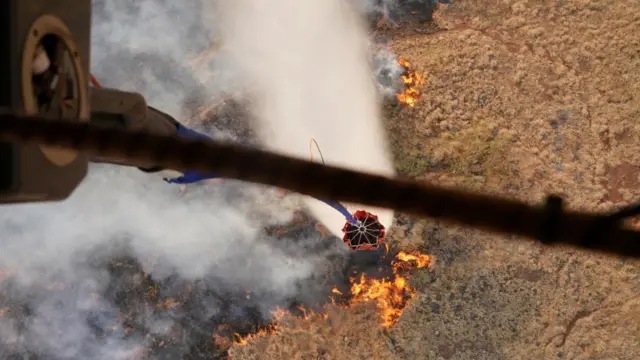 Hawaii Army National Guard CH47 Chinook helicopters perform aerial water bucket drops on the island of Maui to assist with fight of wildfires in Maui, Hawaii, August 9, 2023