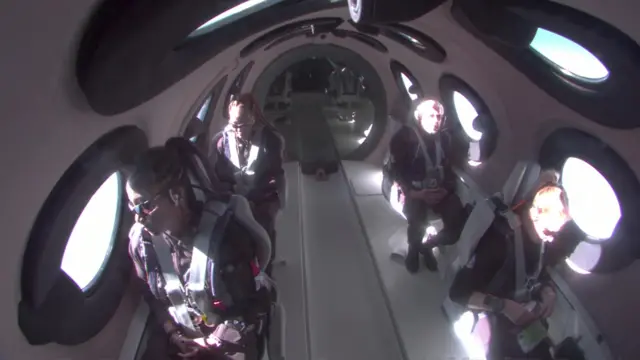 Four passengers pictured sitting inside the Virgin Galactic space flight