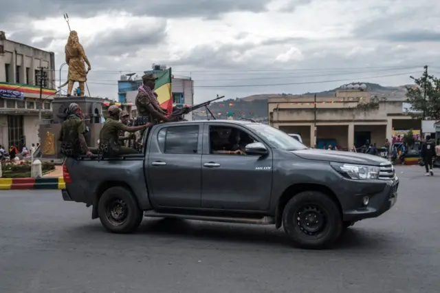 Members of the Amhara militia ride in the back of a pick up truck in the city of Gondar, Ethiopia, on January 17, 2022