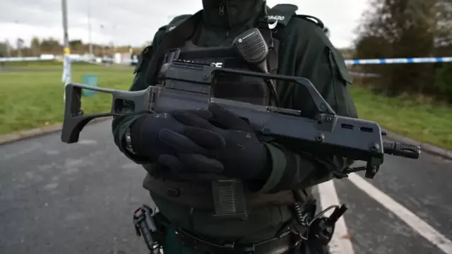 An on duty Police officer holding a gun