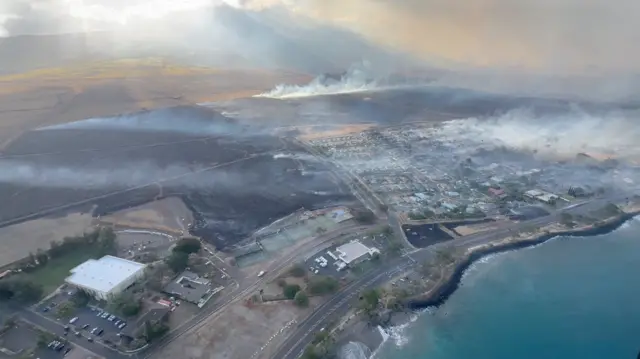 An aerial view shows smoke rising from burnt areas in Maui, Hawaii