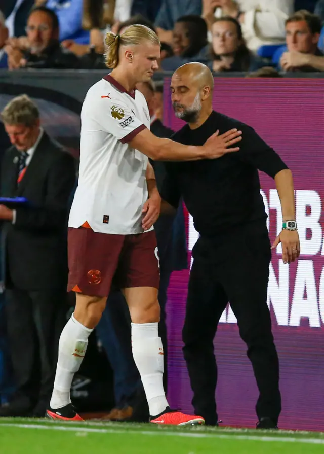 Haaland is congratulated by Guardiola after being subbed off.