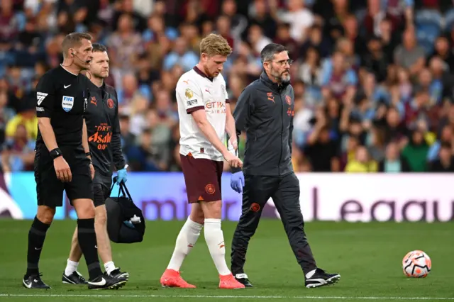 De Bruyne walks off injured removing the armband as he goes.