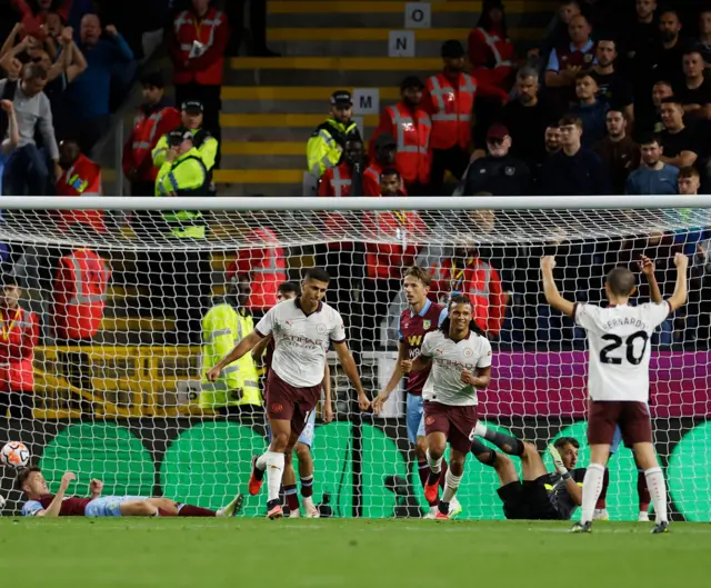 Rodri wheels away after scoring City's third.