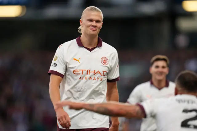 Haaland smirks at Walker after he scores his second goal.