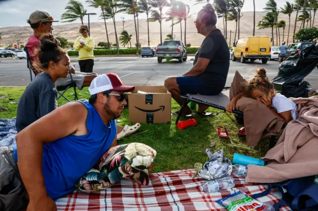 A family waiting to be allowed back into Lahaina