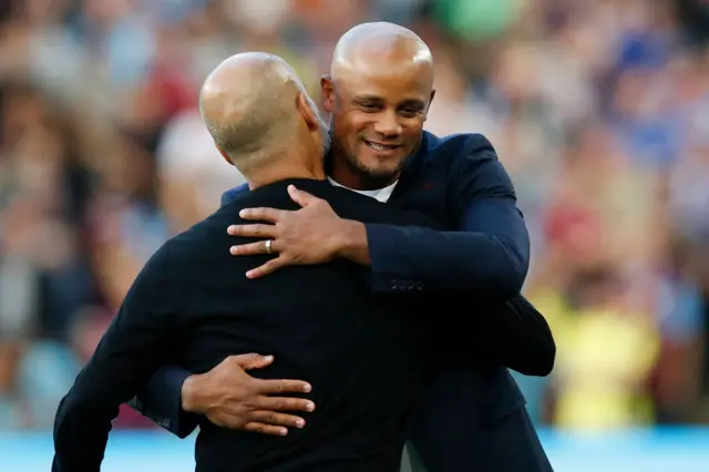 Kompany and Guardiola share a big hug before kick off.