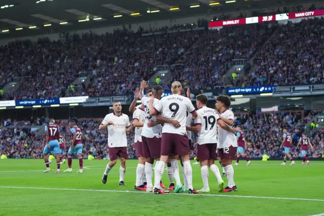 City celebrate again as Burnley players head towards their places for kick off.