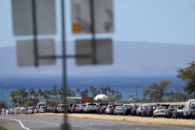 cars in a line with ocean