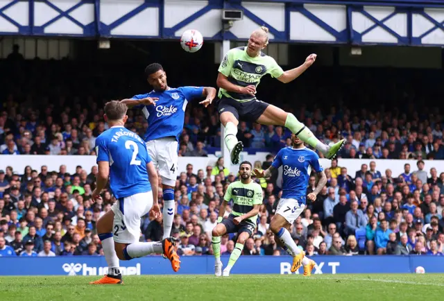 Haaland rises above the Everton defence to score for City.