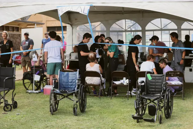 People seek refuge at a shelter set up at the Maui War Memorial in Wailuku, Hawaii