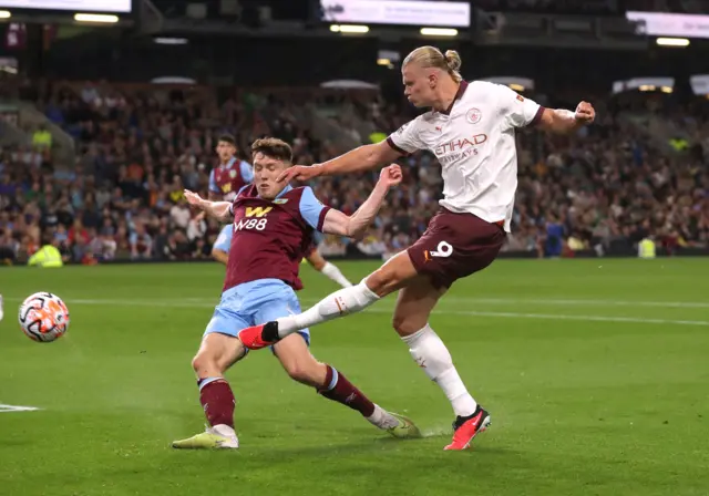 Haaland tries to evade a defender to get the ball in the box from the wing.