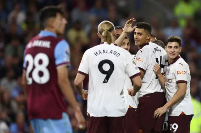 City players celebrate after Rodri adds the third.