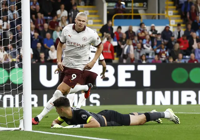 Trafford lies on the floor after conceding early in the game.