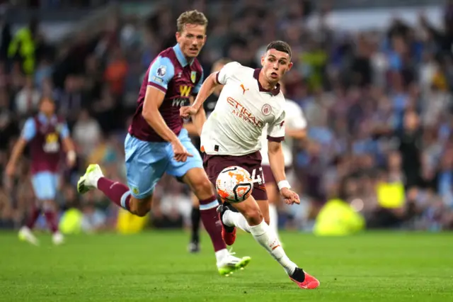 Foden dribbles away from Berge in midfield.