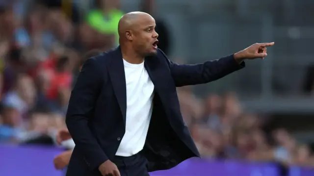 Kompany shouts orders from the touchline.