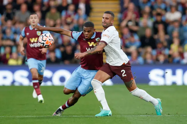 Foster bursts past the challenge of Walker on the wing.