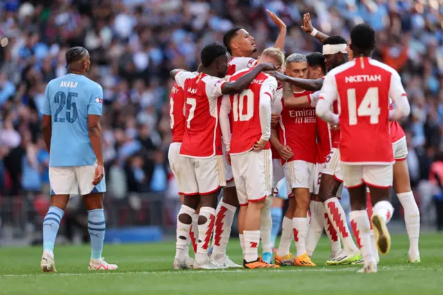 Arsenal players gather after their late equaliser in the community shield.