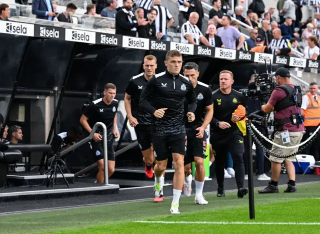 Trippier leads the Newcastle team out to warm up.