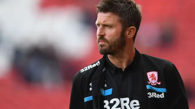 Michael Carrick looks on from the dug out