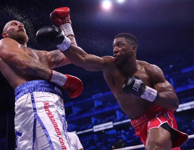 Anthony Joshua landing a punch on Robert Helenius