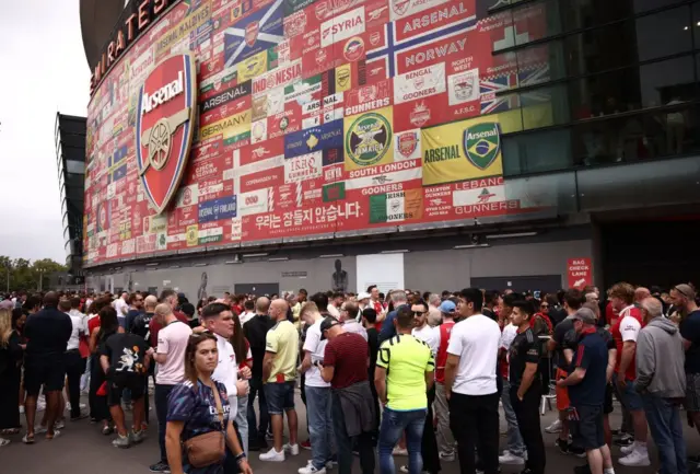 Arsenal fans continue to wait outside the ground.