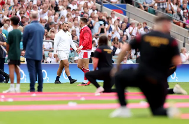 Genge eyes Adams up as they walk onto the pitch