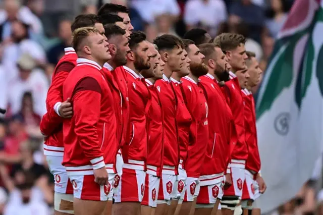 Lake signing the anthem with his team-mates