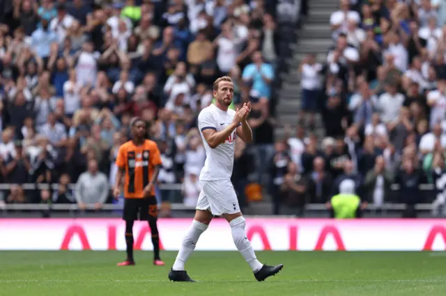 Kane is subbed off as a Shakhtar player looks on.