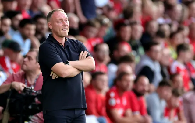 Steve Cooper watches on from the sidelines.