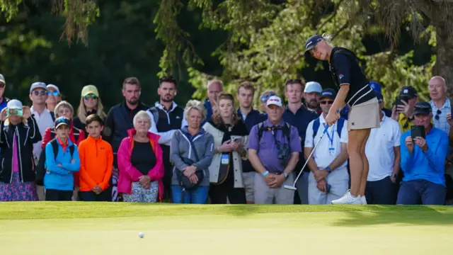 Charley Hull sends a putt towards the hole