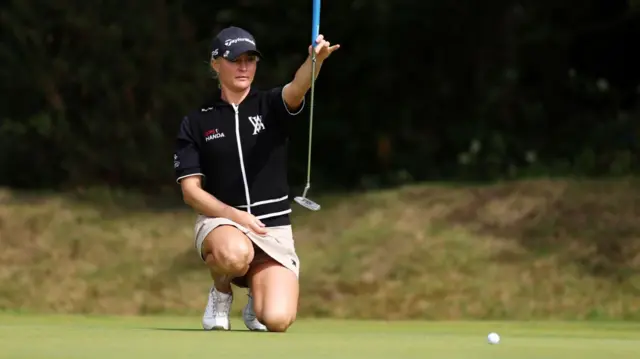 Charley Hull lines up a putt