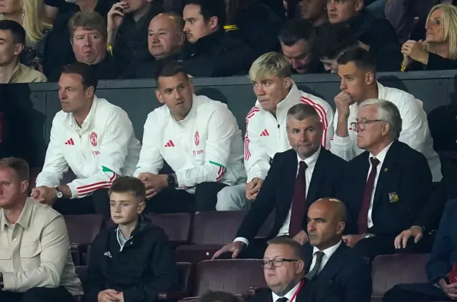 Hojlund sits among the other unavailable players in the stand.