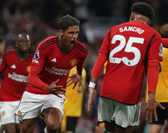 Varane runs to celebrate after opening the scoring.