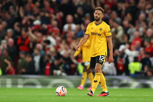 Cunha looks at the floor as he heads back for kick off.