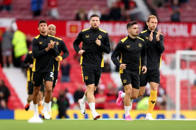 Wolves players take to the pitch to warm up.