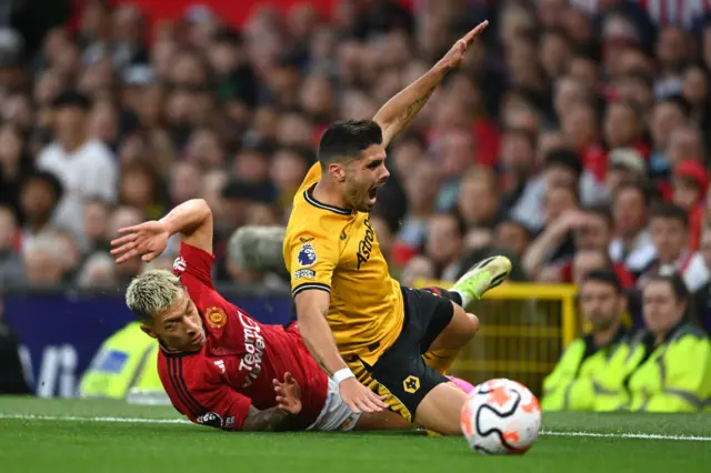 Martinez chops down Neto near the touchline.