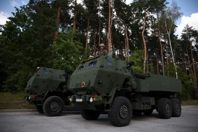 A Polish soldier is seen on a multiple rocket launcher M142 HIMARS during preparations before National Army Day Parade at Wesola military base, in Warsaw.